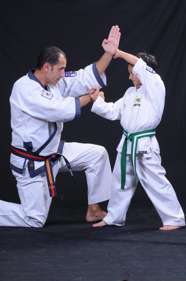 Boy and Man Practicing Tang Soo Do in White Kimonos